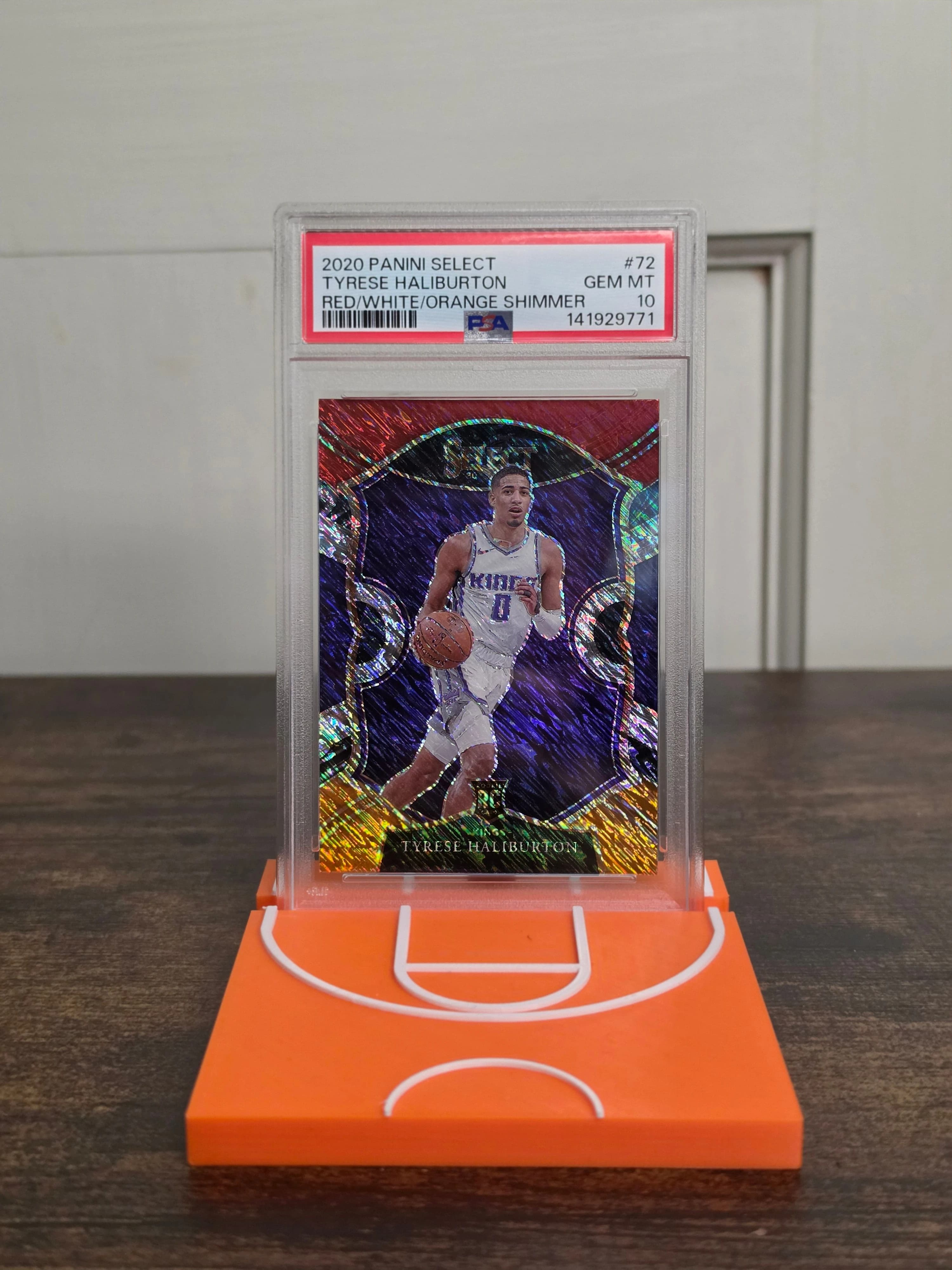 Mini basketball court card stand displaying a graded basketball card